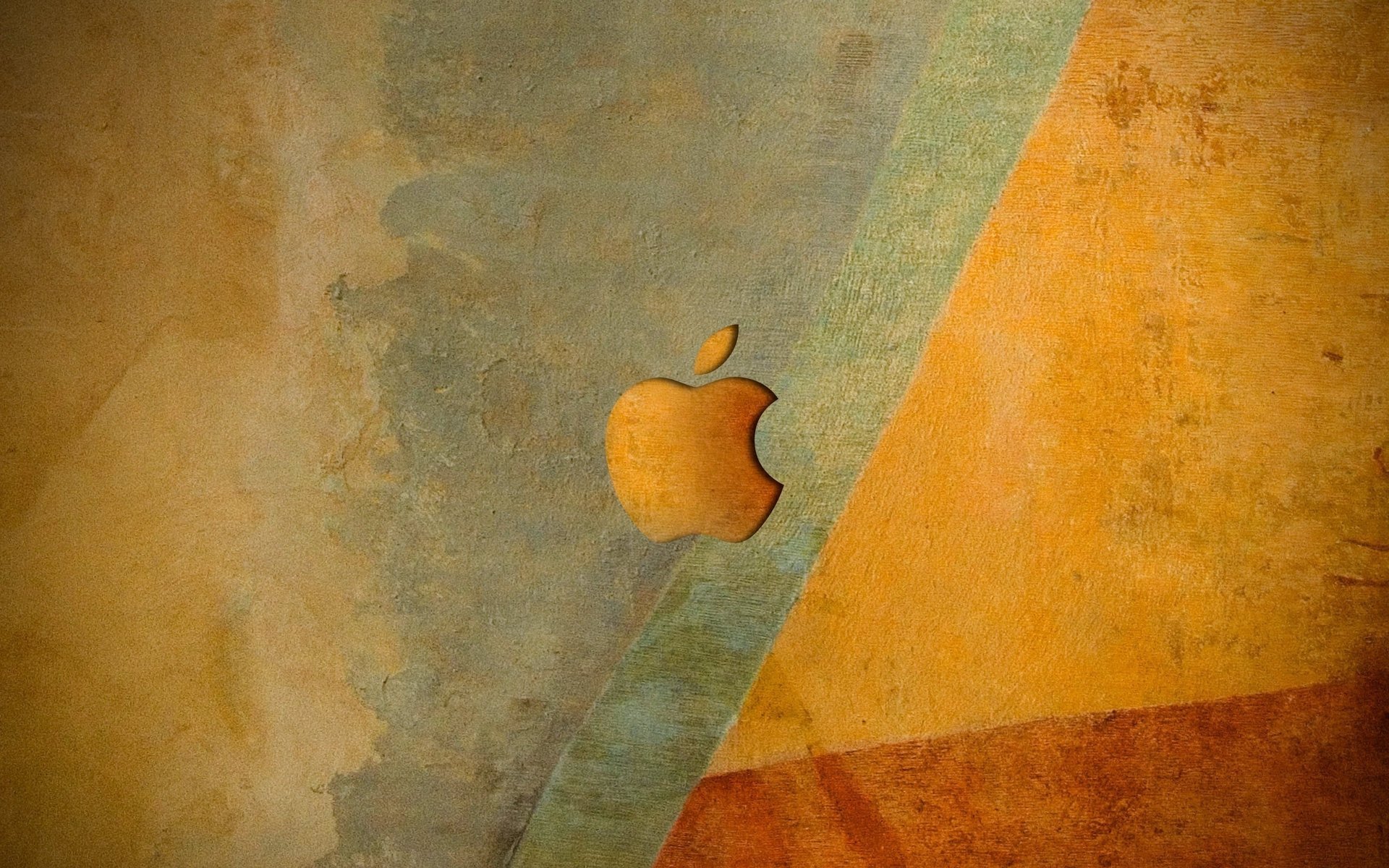 Эмблема apple оранжевых оттенков на фоне стены