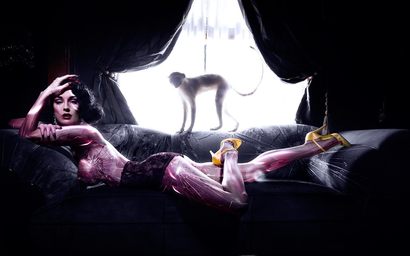 Женщина фотомодель на диване в фиолетовых тонах