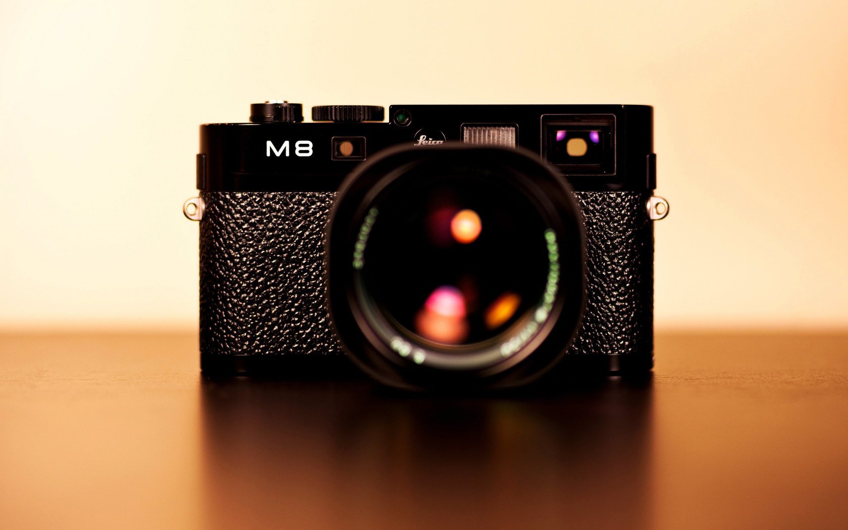 Черный фотоаппарат leica m8 с красивыми бликами в объективе