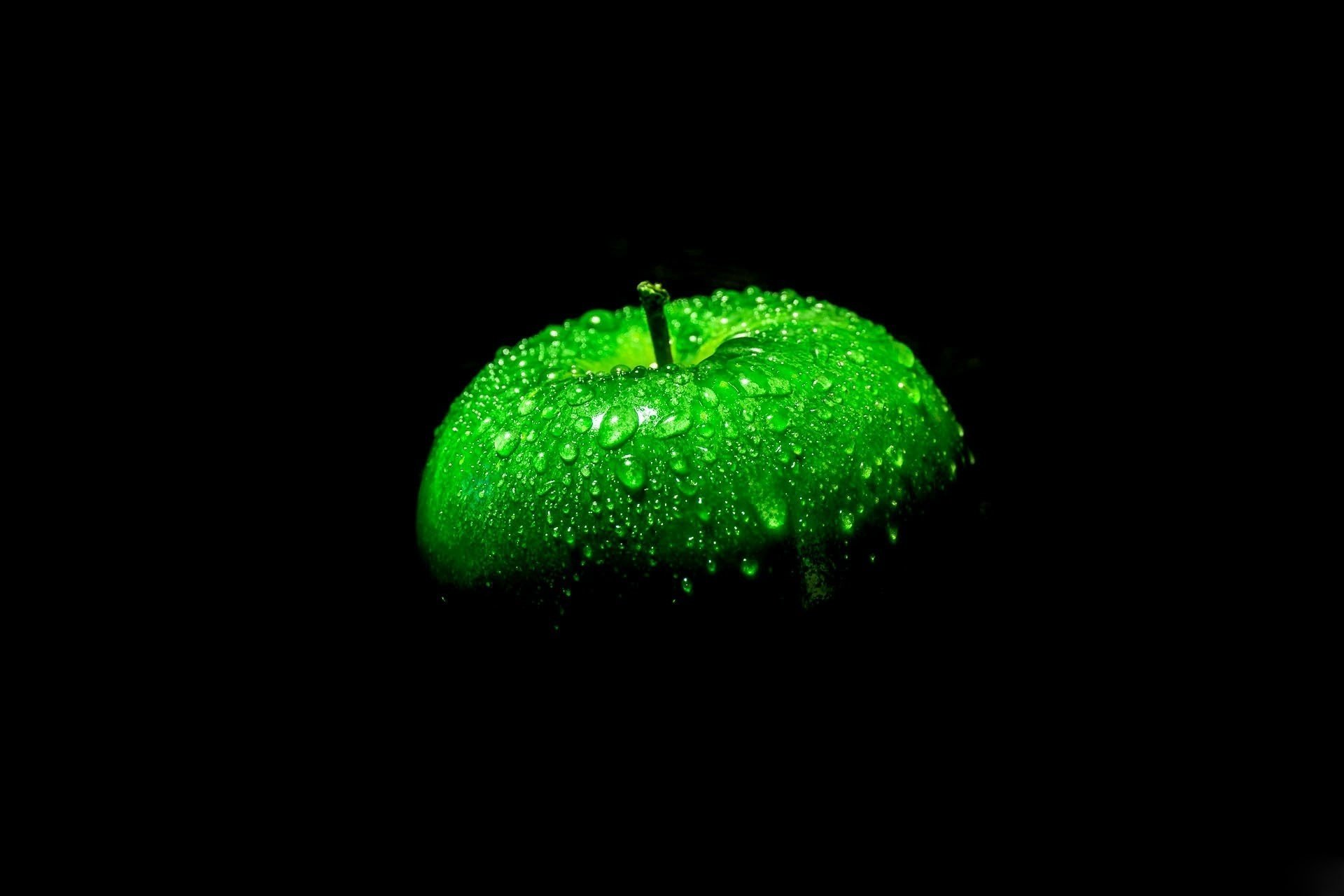 Зелёное яблоко на чёрном фоне