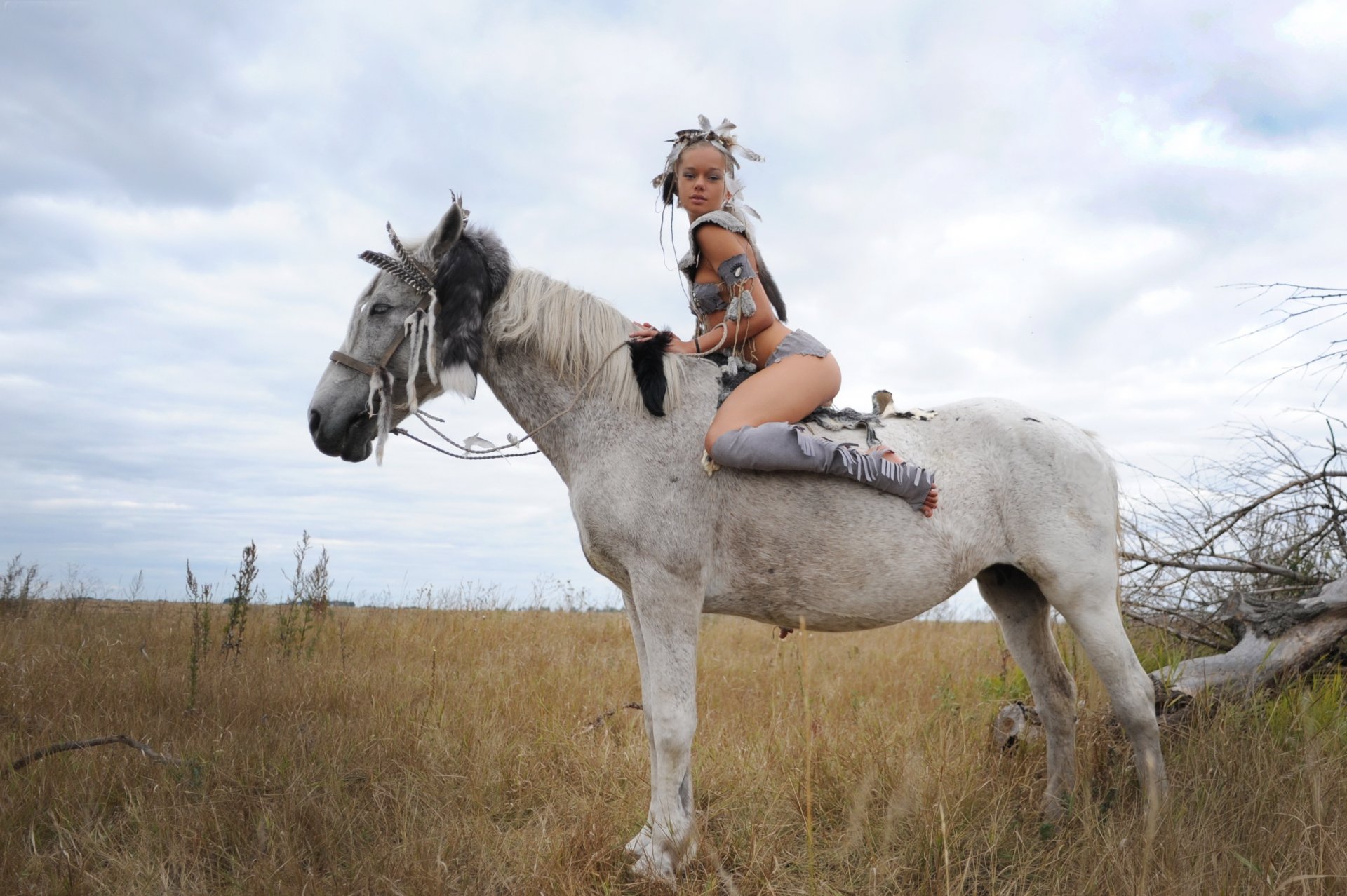 Girl mounted by horse